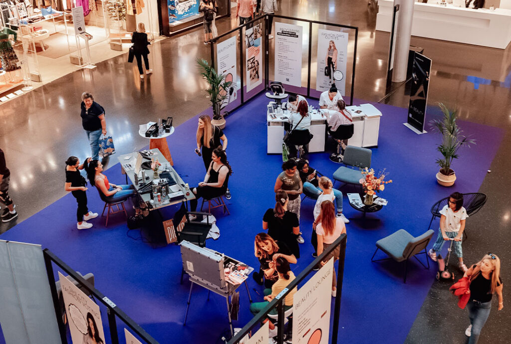Menschen bei Messestand in Einkaufszentrum